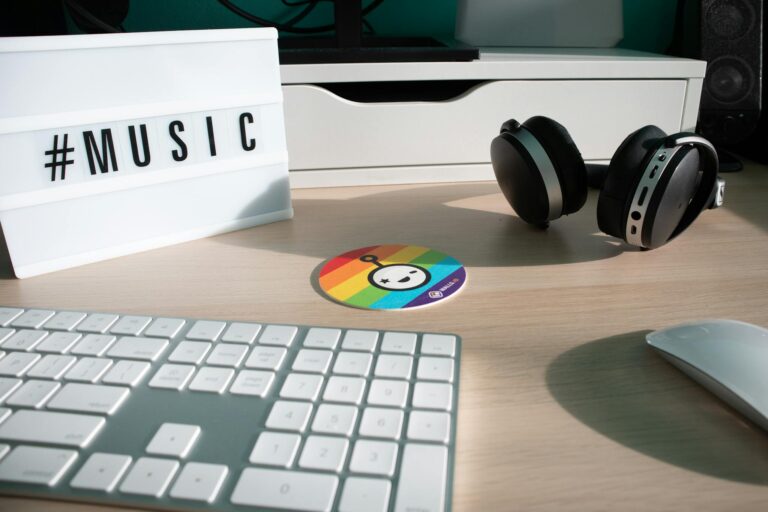 A modern workspace featuring headphones, keyboard, and music theme.